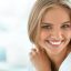 Beautiful Woman Smiling. Portrait Of Attractive Happy Healthy Girl With Perfect Smile, White Teeth, Blonde Hair And Fresh Face Smiling Indoors. Beauty And Health Concept. High Resolution Image